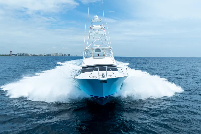 Knotty Girl Yacht Photos Pics 2005 Viking 52 Convertible yacht cruising on open water.