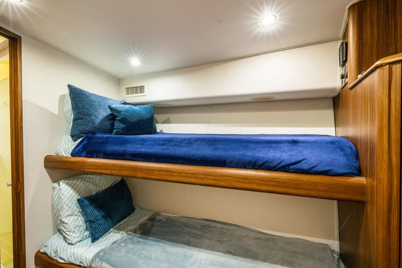Knotty Girl Yacht Photos Pics Bunk beds in the 2005 Viking 52 Convertible yacht cabin, featuring cozy blue bedding.