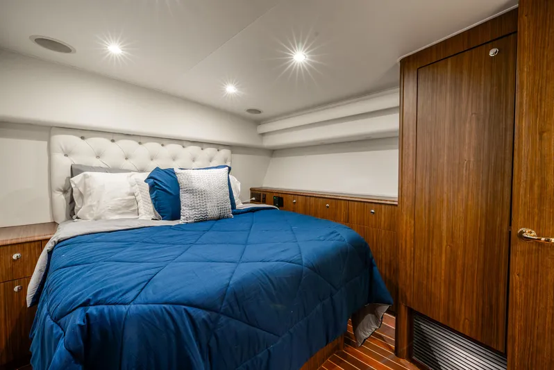 Knotty Girl Yacht Photos Pics Luxurious bedroom interior of 2005 Viking 52 Convertible yacht with blue bedding.