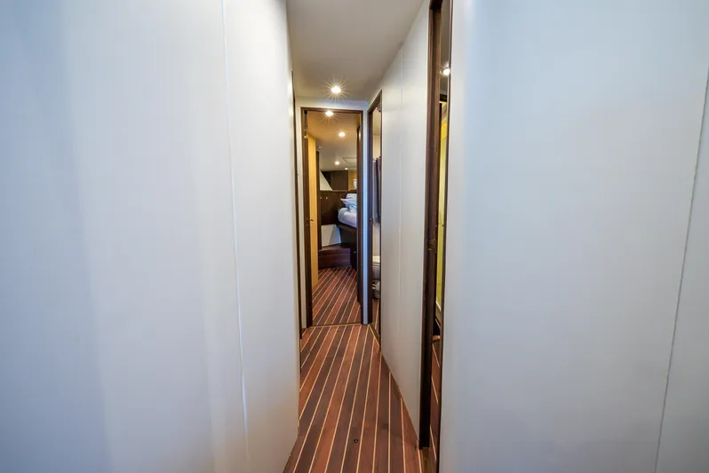 Knotty Girl Yacht Photos Pics Hallway interior of 2005 Viking 52 Convertible yacht with wood flooring and recessed lighting.