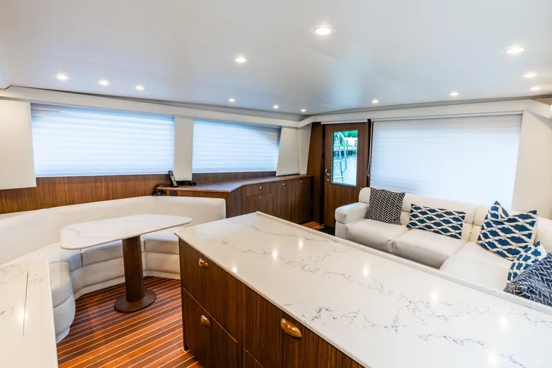 Knotty Girl Yacht Photos Pics Luxurious interior of 2005 Viking 52 Convertible yacht with modern furnishings.