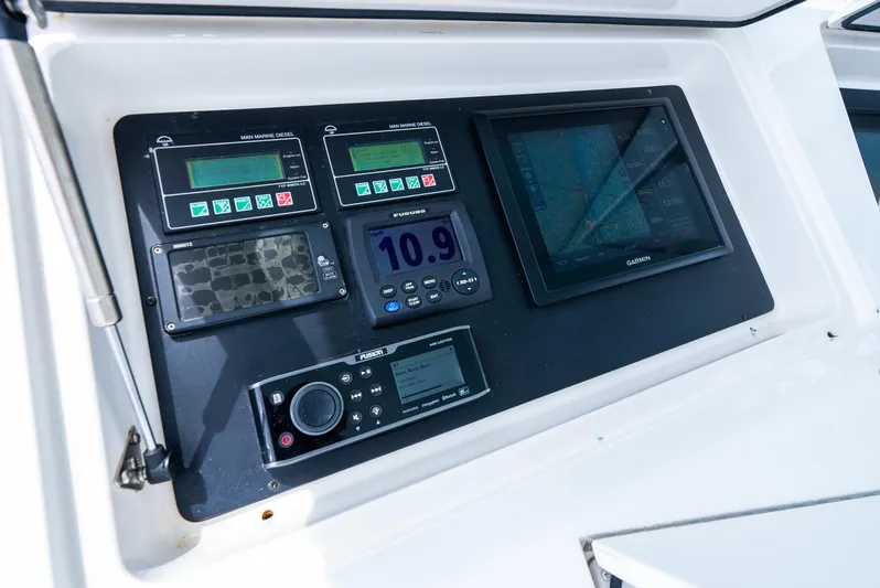 Knotty Girl Yacht Photos Pics Control panel of a 2005 Viking 52 Convertible yacht with navigation instruments.