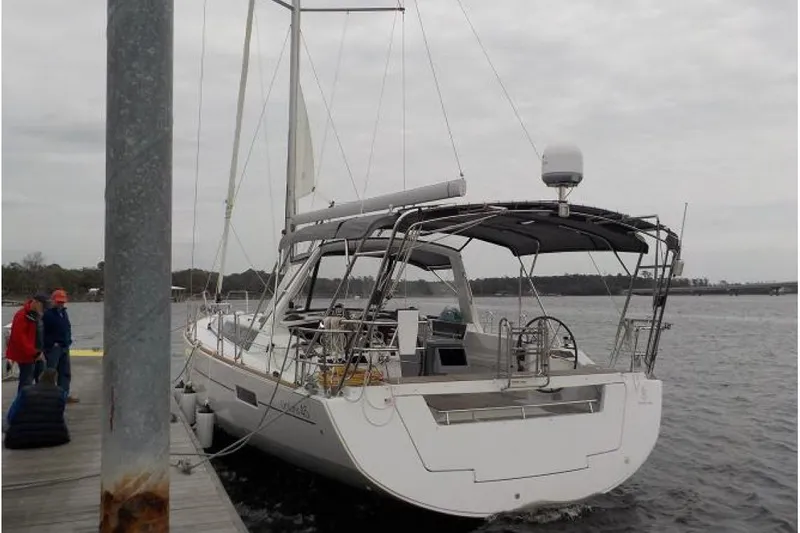  Yacht Photos Pics 2017 Beneteau Oceanis 45 sailboat docked at a marina on a cloudy day.