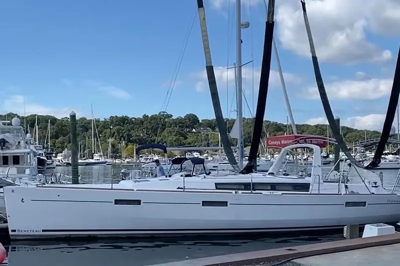  Yacht Photos Pics 2017 Beneteau Oceanis 45 sailboat docked at a marina under a clear blue sky.
