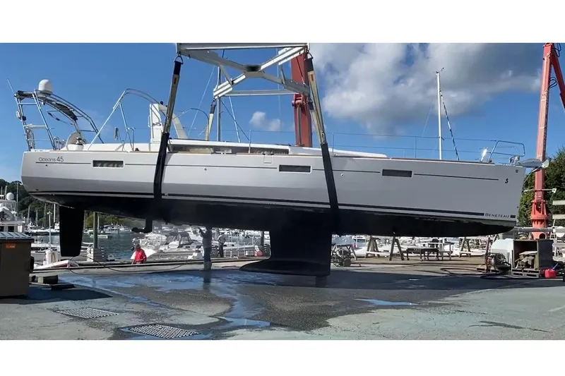  Yacht Photos Pics 2017 Beneteau Oceanis 45 sailboat lifted at marina, clear sky background.
