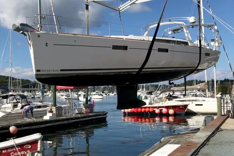  Yacht Photos Pics 2017 Beneteau Oceanis 45 sailboat being lifted at a marina.