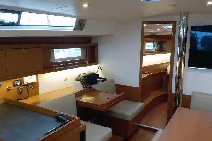  Yacht Photos Pics Interior of 2017 Beneteau Oceanis 45 yacht, featuring modern wood finish and seating area.