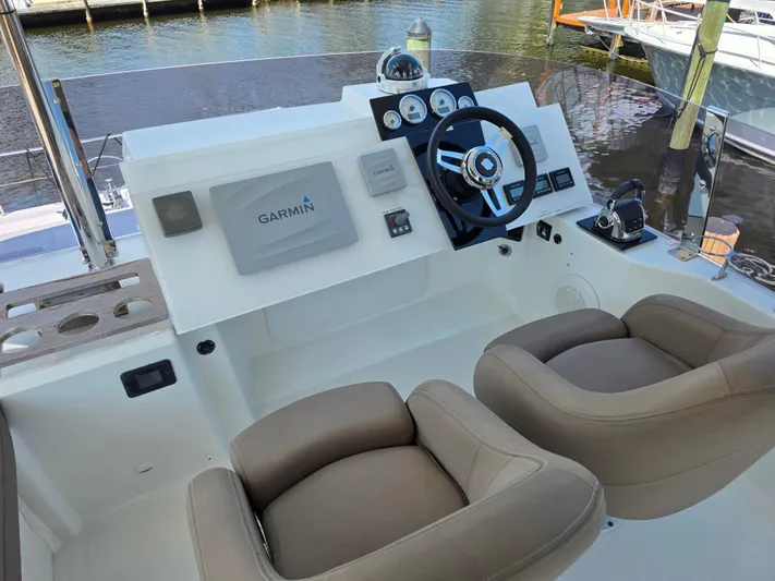 Neptune's Revenge Yacht Photos Pics Helm of 2017 Fountaine Pajot MY37 with Garmin navigation, dual seats, and modern controls.