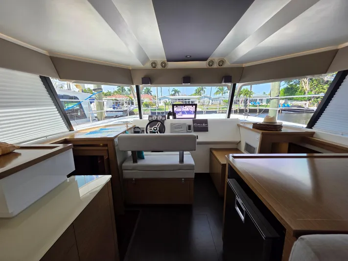 Neptune's Revenge Yacht Photos Pics Interior of 2017 Fountaine Pajot MY37 yacht with modern helm and panoramic windows.