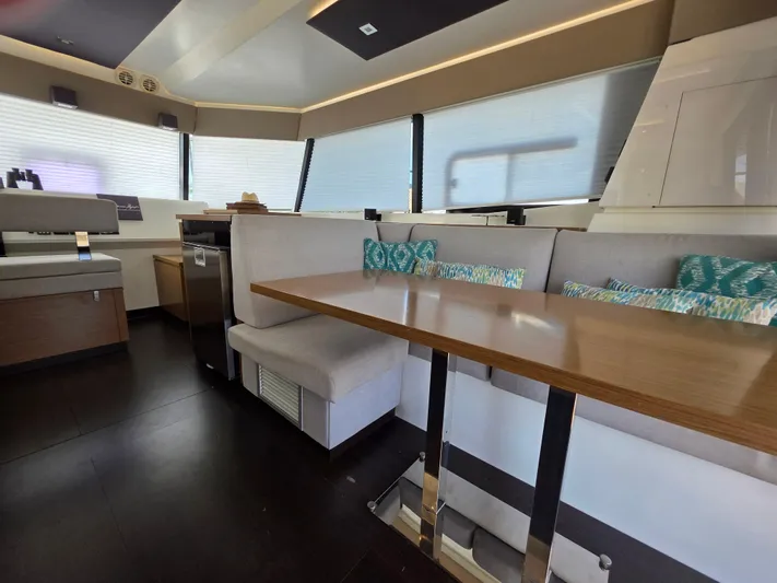 Neptune's Revenge Yacht Photos Pics Luxurious interior of 2017 Fountaine Pajot MY37 yacht with modern seating and dining area.