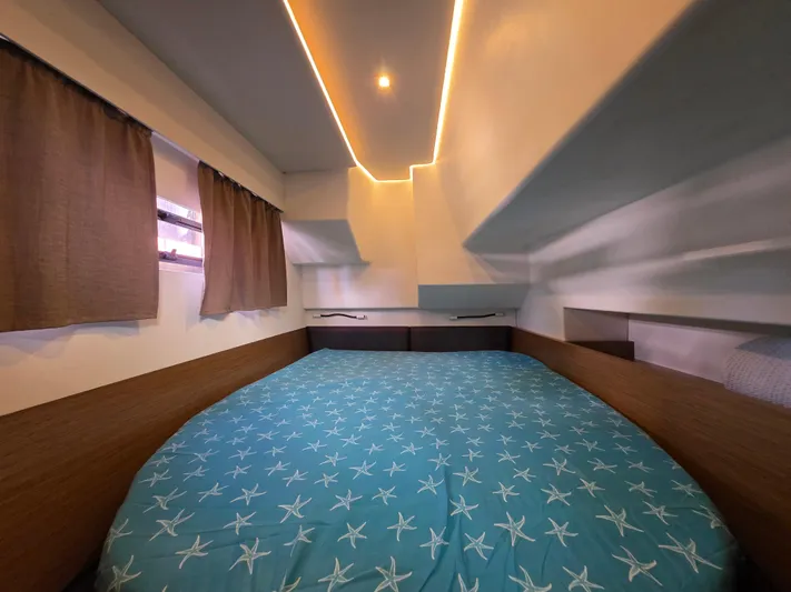 Neptune's Revenge Yacht Photos Pics Cozy bedroom in 2017 Fountaine Pajot MY37 yacht with starfish-patterned bedding.