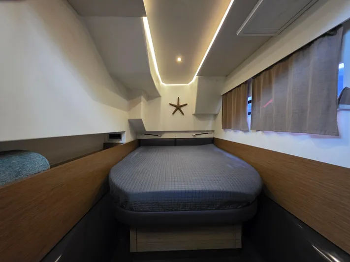 Neptune's Revenge Yacht Photos Pics Luxurious cabin interior of 2017 Fountaine Pajot MY37 with modern lighting and cozy bedding.