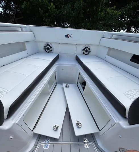  Yacht Photos Pics 2024 Crevalle 33 CSF boat interior with open storage compartments and cushioned seating.