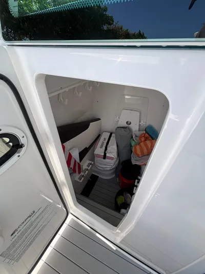  Yacht Photos Pics Storage compartment on a 2024 Crevalle 33 CSF boat, containing various items.