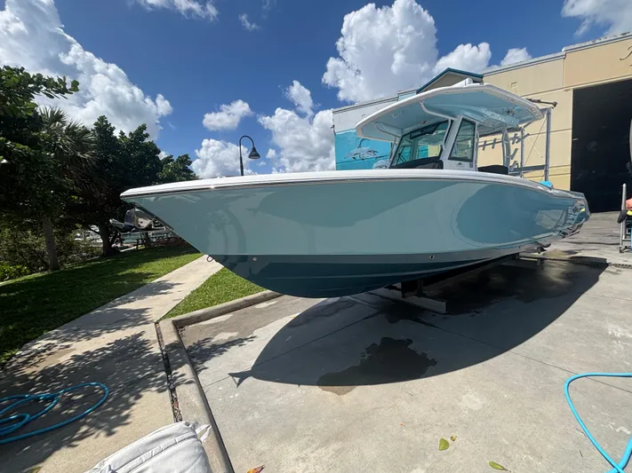  Yacht Photos Pics 2024 Crevalle 33 CSF boat on display, sunny day, blue sky, and clouds.