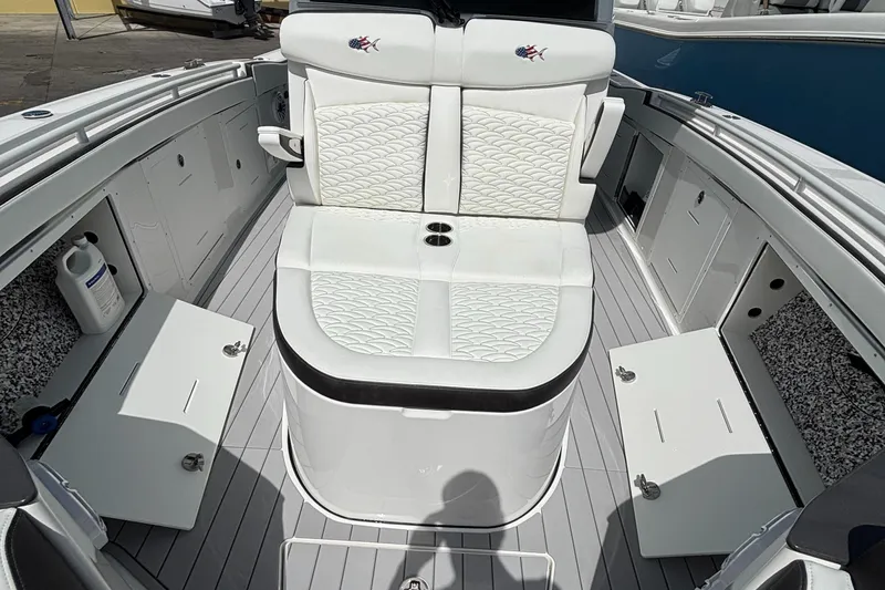  Yacht Photos Pics 2024 Crevalle 33 CSF boat interior with white seating and storage compartments.