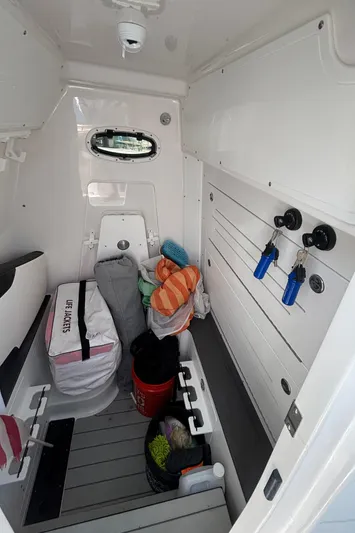  Yacht Photos Pics 2024 Crevalle 33 CSF cabin interior with storage, equipment, and porthole.
