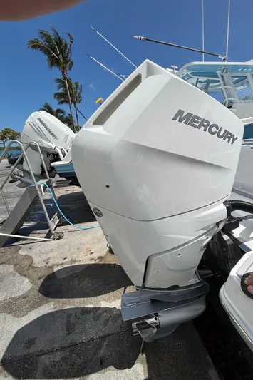  Yacht Photos Pics 2024 Crevalle 33 CSF boat with Mercury outboard motor, docked under clear blue sky.