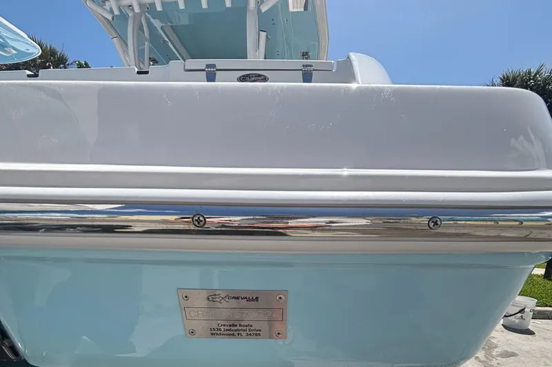  Yacht Photos Pics 2024 Crevalle 33 CSF boat, rear view with manufacturer plaque, light blue and white design.