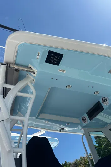  Yacht Photos Pics 2024 Crevalle 33 CSF boat, view of the overhead console and speakers under clear blue sky.