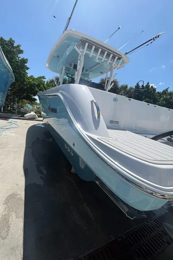  Yacht Photos Pics 2024 Crevalle 33 CSF boat with sleek design, docked under clear blue sky.