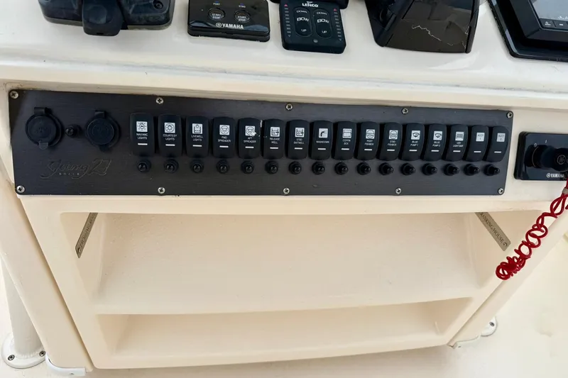  Yacht Photos Pics Control panel of a 2019 Young Boats 27, featuring various switches and Yamaha controls.