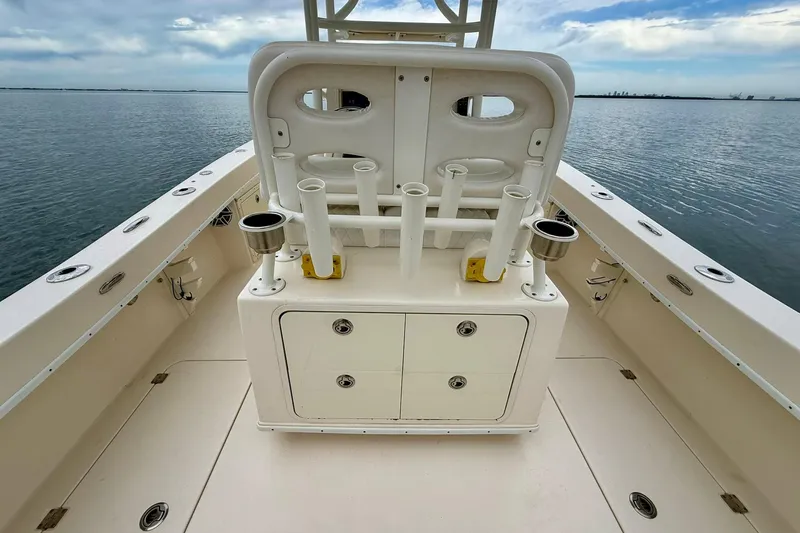  Yacht Photos Pics 2019 Young Boats 27 model, spacious deck with rod holders and storage, on calm water.