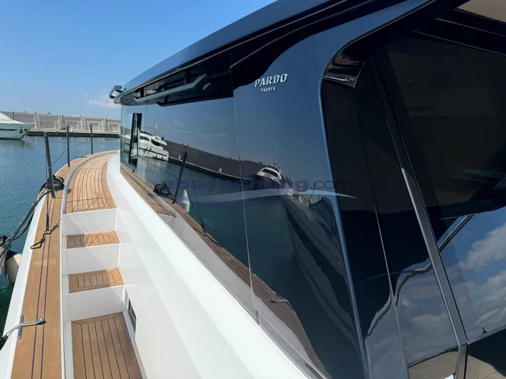  Yacht Photos Pics 2022 Pardo Yachts GT52 with sleek design and wooden deck, docked at marina.