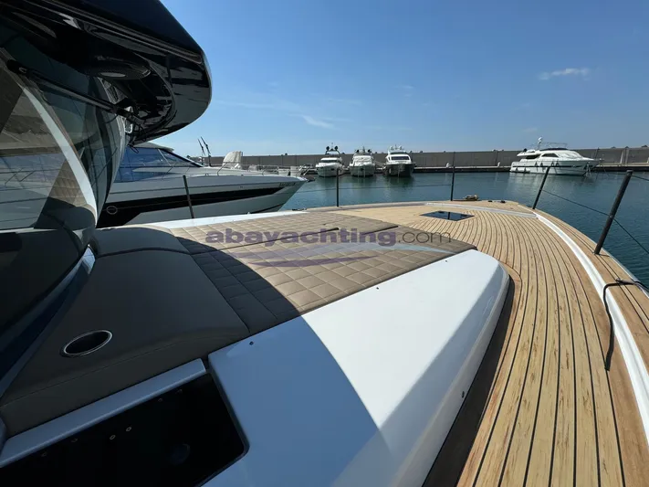  Yacht Photos Pics 2022 Pardo Yachts GT52 with sleek deck design, docked in a marina under clear skies.