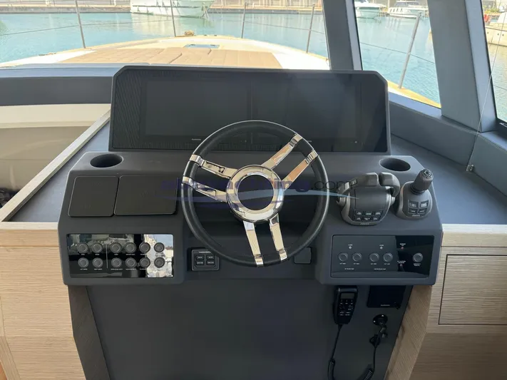  Yacht Photos Pics Helm of 2022 Pardo Yachts GT52 with steering wheel and control panel, docked at marina.