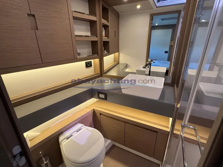  Yacht Photos Pics Luxurious bathroom in 2022 Pardo Yachts GT52, featuring modern fixtures and elegant wood cabinetry.