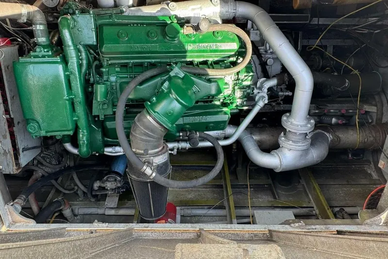 Deep Sea Traveler Yacht Photos Pics Green engine inside a 1964 custom commercial vehicle, showcasing intricate piping and components.