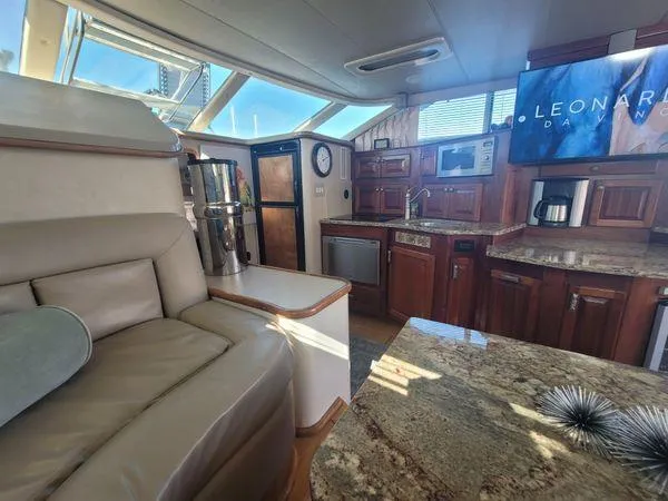 Backatcha Yacht Photos Pics Interior of 1995 Sea Ray 440 Express Bridge with luxurious seating and modern kitchen amenities.
