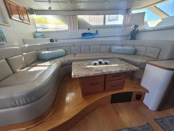 Backatcha Yacht Photos Pics Luxurious interior of 1995 Sea Ray 440 Express Bridge with plush seating and elegant decor.