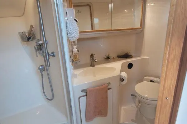 Backatcha Yacht Photos Pics Bathroom interior of 1995 Sea Ray 440 Express Bridge yacht, featuring shower and sink.