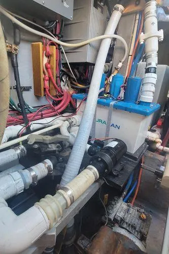 Backatcha Yacht Photos Pics Engine room of 1995 Sea Ray 440 Express Bridge with visible pipes and wiring.