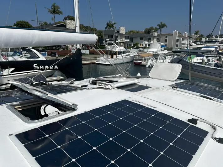2.0 Impulsive Yacht Photos Pics Beneteau 57 sailboat (2005) with solar panels docked in a marina.