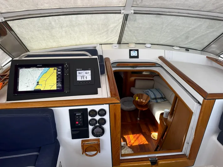 2.0 Impulsive Yacht Photos Pics Beneteau 57 yacht interior, 2005 model, featuring navigation equipment and cozy cabin entrance.