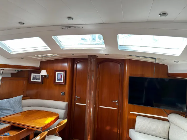 2.0 Impulsive Yacht Photos Pics Luxurious interior of 2005 Beneteau 57 yacht with skylights and elegant wood finish.
