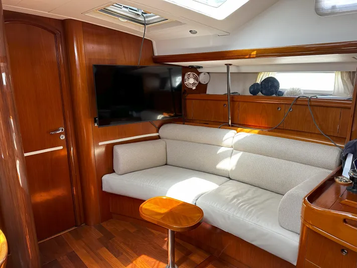 2.0 Impulsive Yacht Photos Pics Luxurious interior of 2005 Beneteau 57 yacht with plush seating and modern amenities.