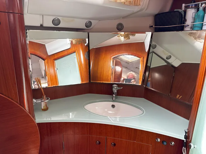 2.0 Impulsive Yacht Photos Pics Luxurious Beneteau 57 yacht bathroom with wood accents and modern fixtures, 2005 model.