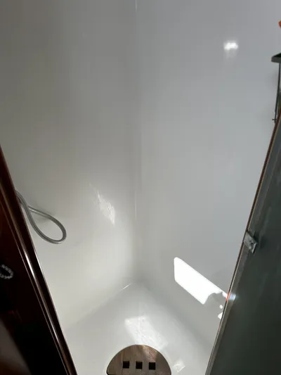 2.0 Impulsive Yacht Photos Pics Shower area in 2005 Beneteau 57 yacht, featuring sleek white interior.