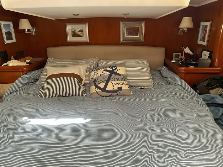 2.0 Impulsive Yacht Photos Pics Luxurious bedroom interior of 2005 Beneteau 57 yacht with nautical-themed decor.