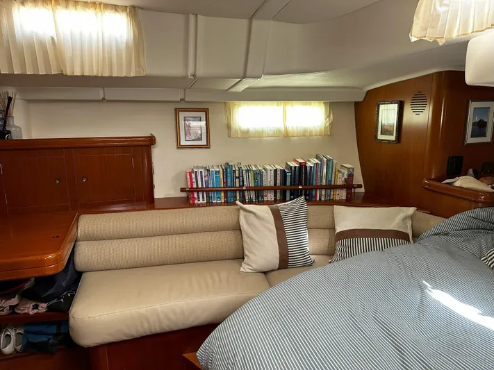 2.0 Impulsive Yacht Photos Pics Cozy interior of 2005 Beneteau 57 yacht with bookshelves and seating area.