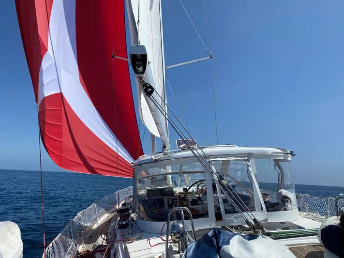 2.0 Impulsive Yacht Photos Pics 2005 Beneteau 57 sailboat with red and white sails on open sea.