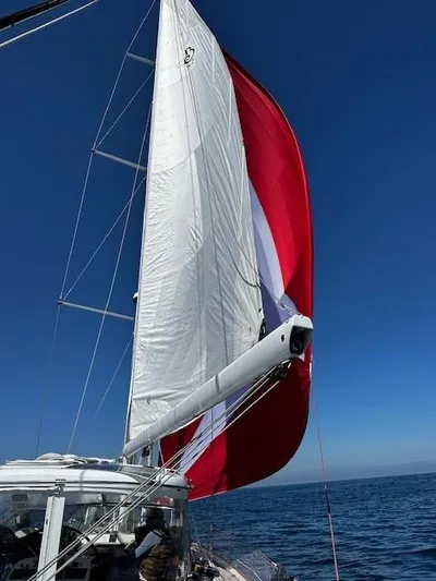 2.0 Impulsive Yacht Photos Pics 2005 Beneteau 57 sailboat with red and white sails on open sea.
