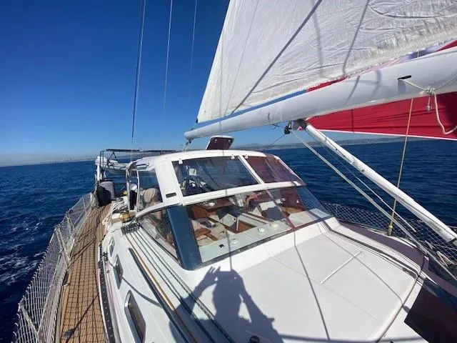 2.0 Impulsive Yacht Photos Pics Sailing on a 2005 Beneteau 57 yacht with white sails and clear blue skies.