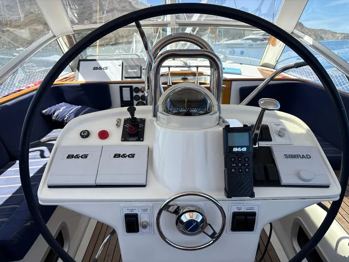 2.0 Impulsive Yacht Photos Pics Cockpit of 2005 Beneteau 57 yacht with navigation equipment and steering wheel.