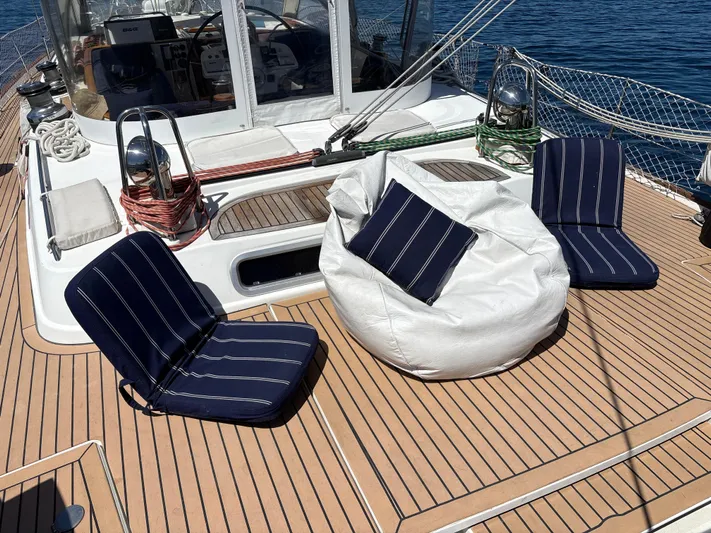 2.0 Impulsive Yacht Photos Pics Deck of 2005 Beneteau 57 yacht with striped cushions and bean bag seating.