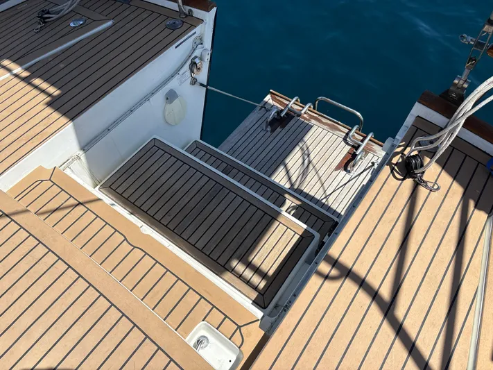 2.0 Impulsive Yacht Photos Pics Beneteau 57 yacht deck, 2005 model, featuring teak wood finish and ocean backdrop.